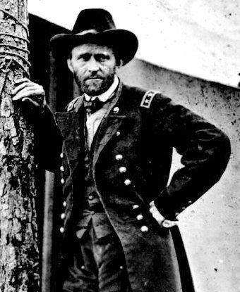Photo of Ulysses S. Grant leaning against a tree trunk in front of a white canvas tent.